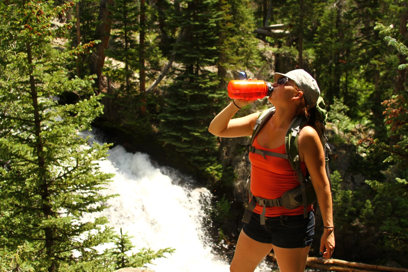 Colorado Mountain Living Woman Drink Water from Gold Creek