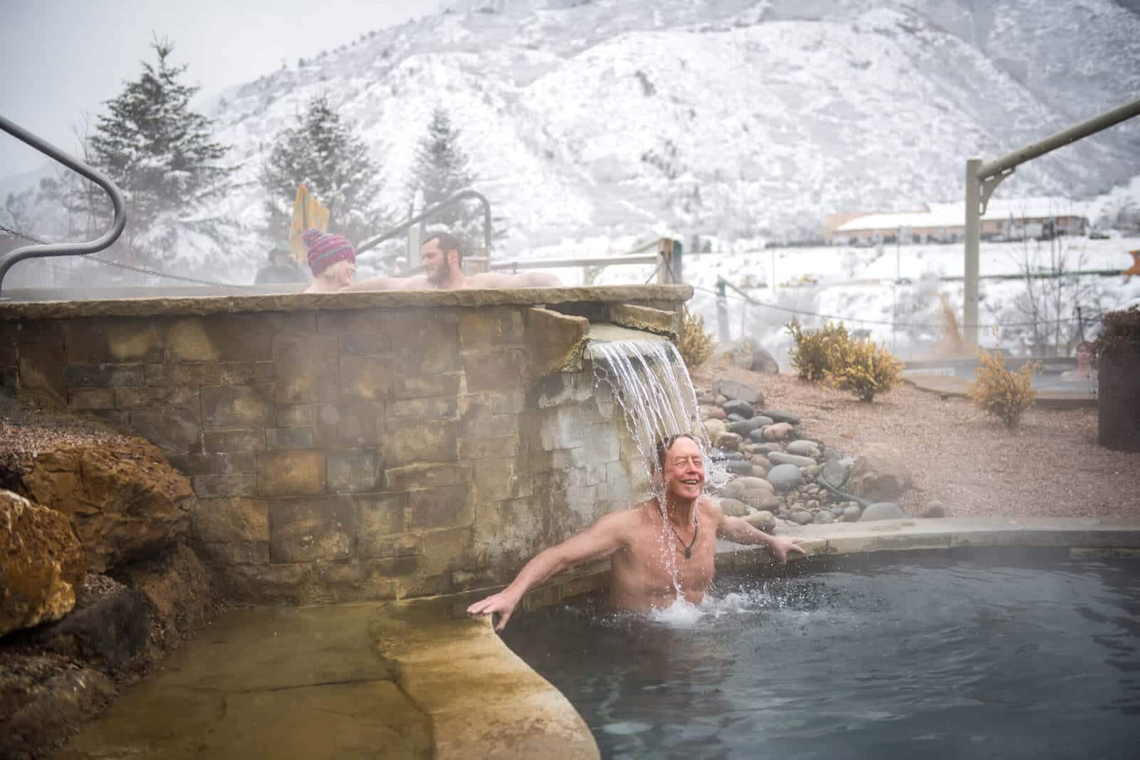 Iron Mountain Hot Springs Glenwood Springs Colorado Man Under Waterfall Pool