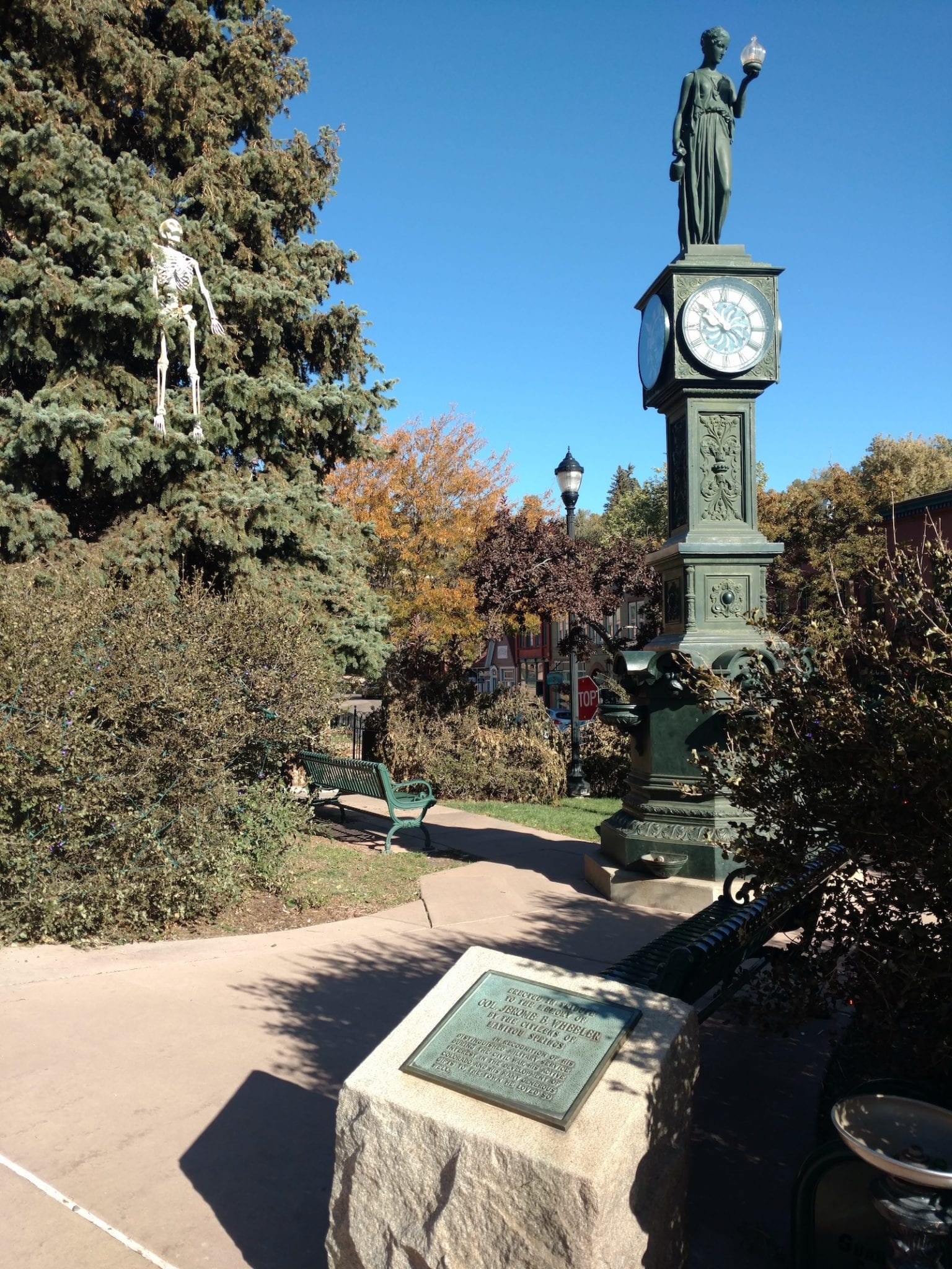 Town Clock With Skeleton in Tree Colorado Springs ArtWalk
