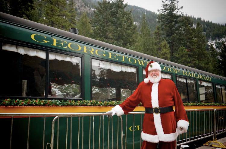 image of Santa in front of train