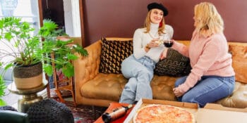 Image of two people enjoying The Infinite Monkey Theorem wine and Sexy Pizza in Denver, Colorado