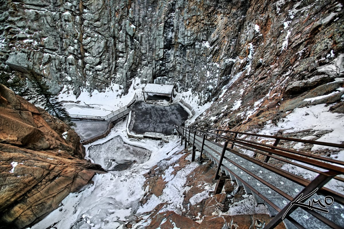 Looking down the steep steps at Seven Falls with snow around