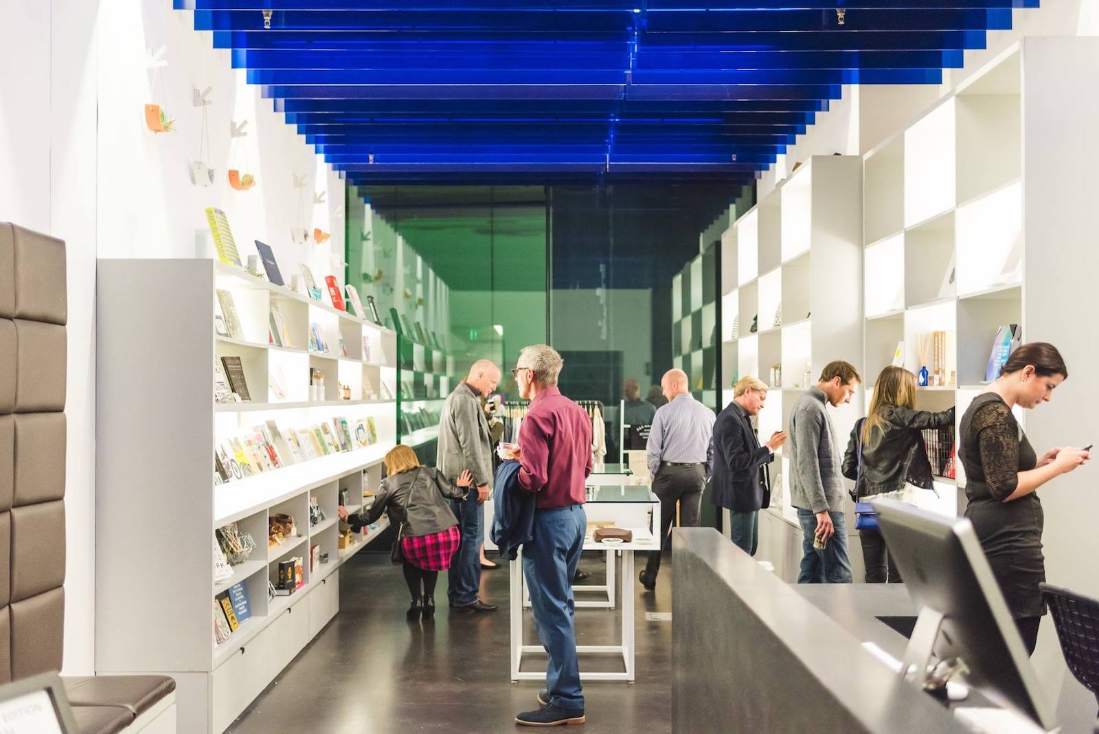 people looking at bookshelves inside the Museum of Contemporary Art