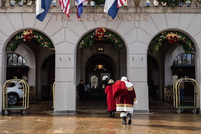 Santa and Mrs. Claus walk in The Broadmoor hotel