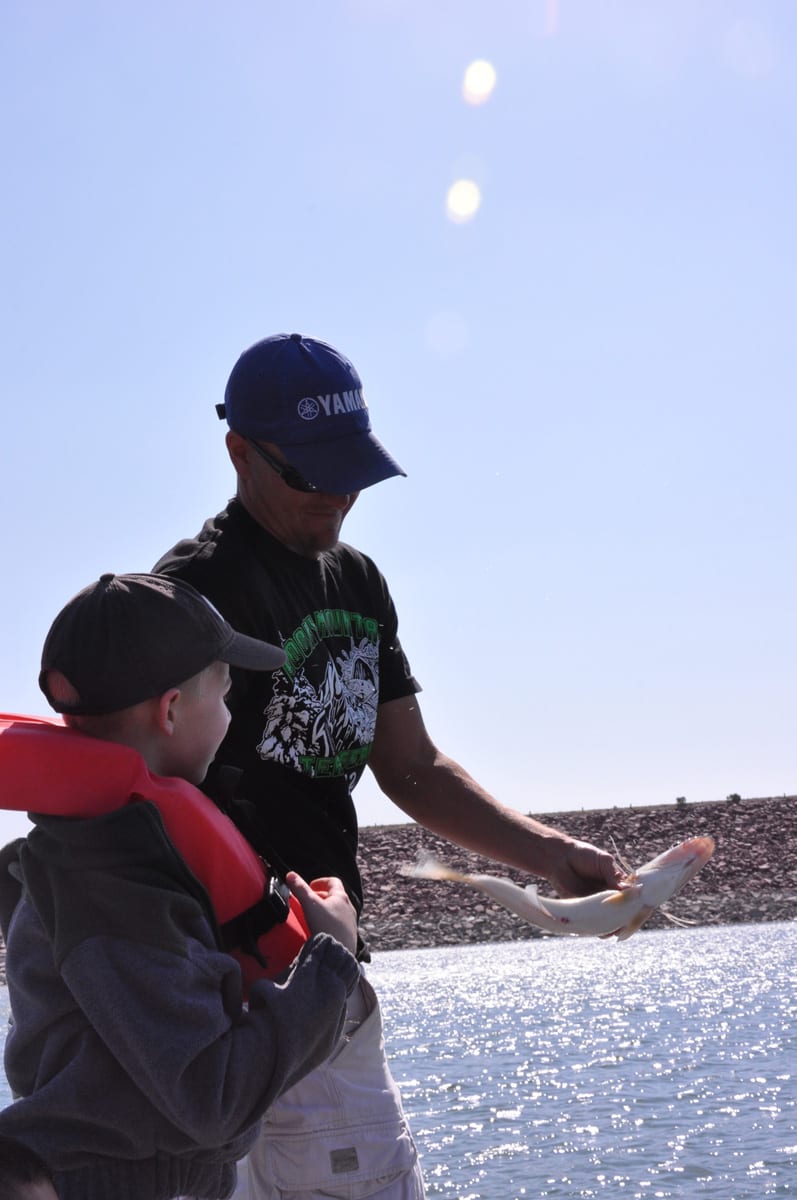Kid and Adult Catch Fish at Pueblo Reservoir Colorado