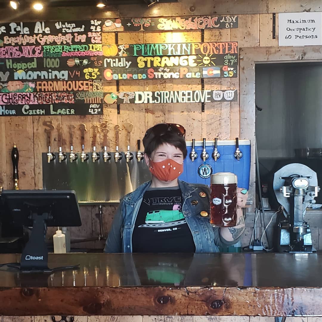 Strange Craft Beer Company Denver CO Bartender holding beer