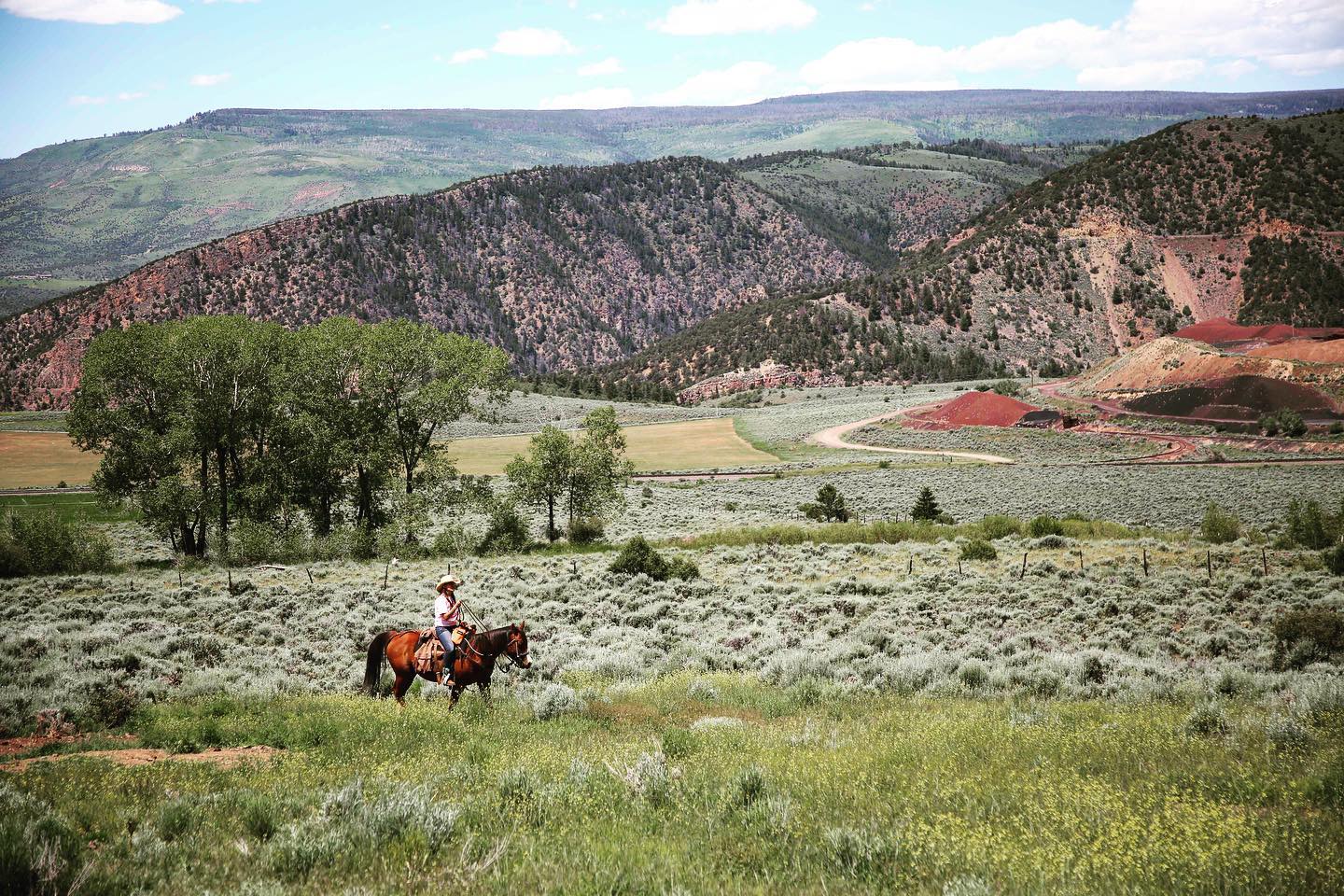 Image of a lone horseback rider at Black Mountain Ranch, CO