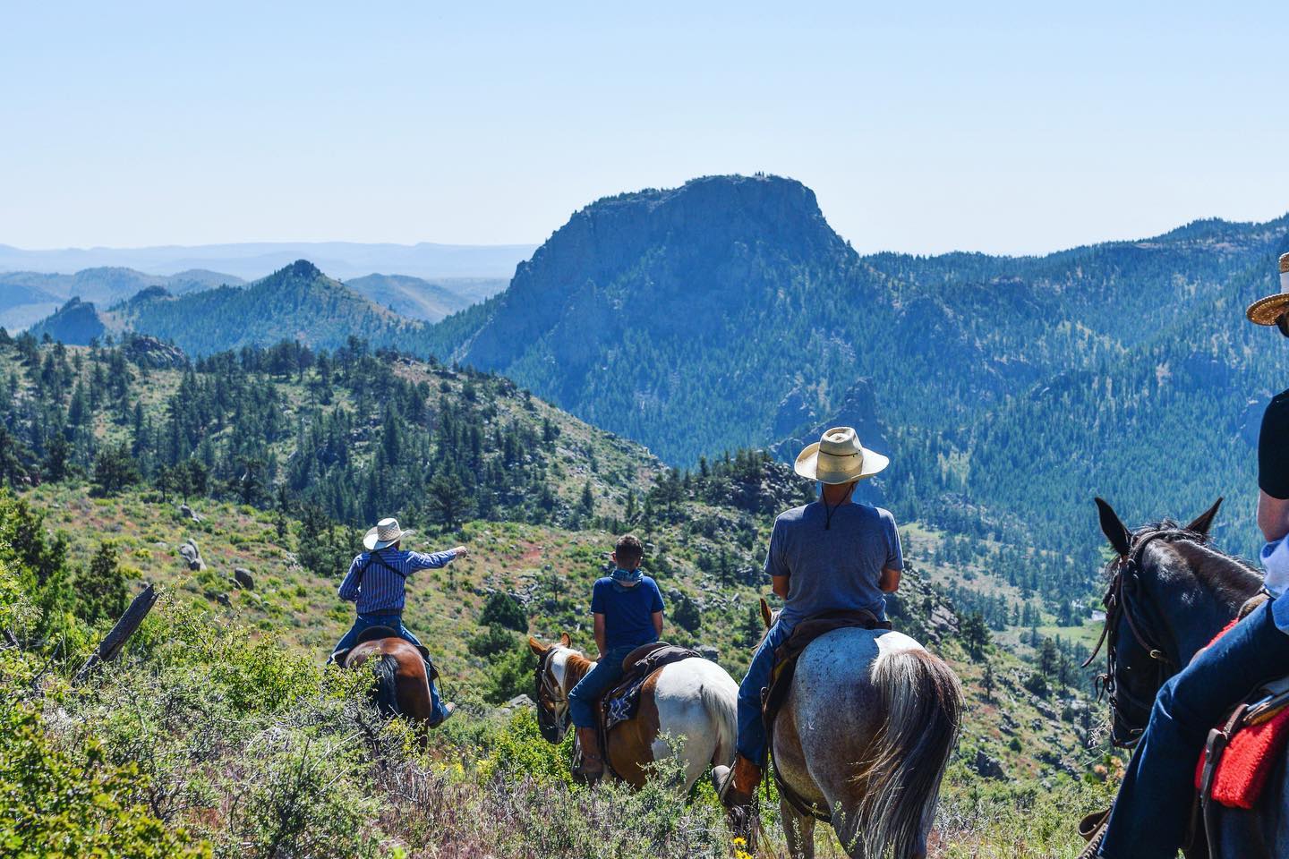 Image of horseback riders in the mountains at Cherokee Park Ranch, CO