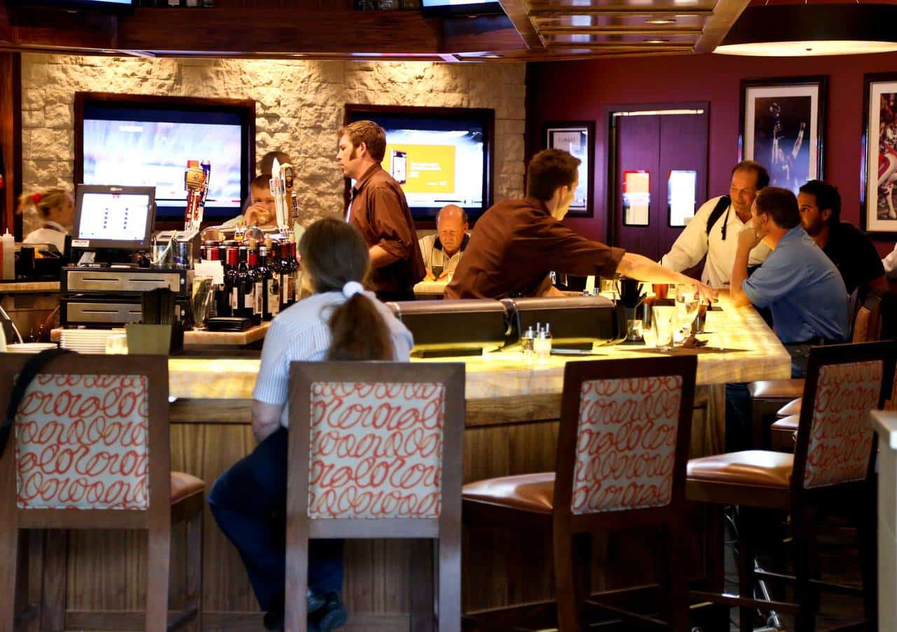 People sitting at a bar at Elway's in Denver International Airport