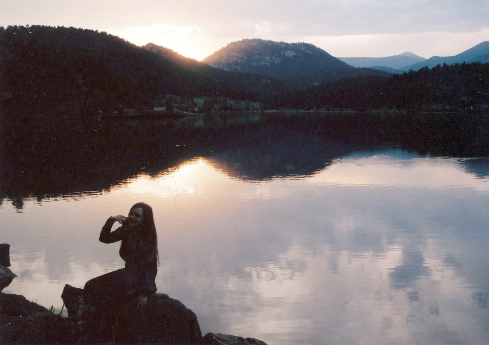 Woman sitting beside Evergreen Lake Colorado