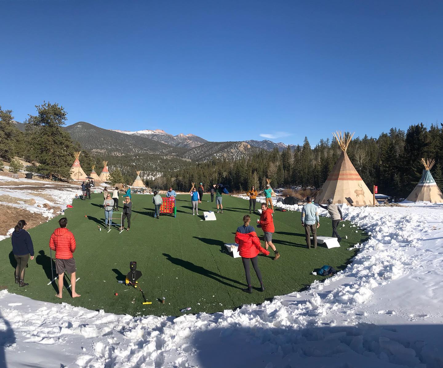 Image of people playing corn hole at Bison Peak Lodge at Puma Hills in Colorado