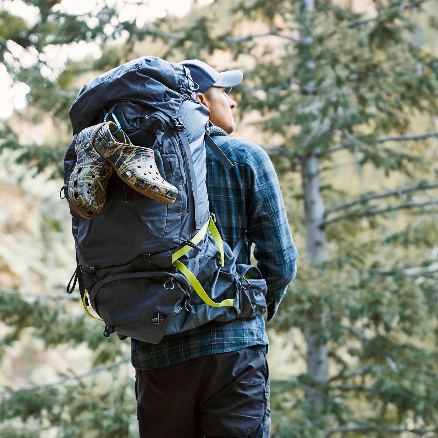 Image of a man hiking with crocs