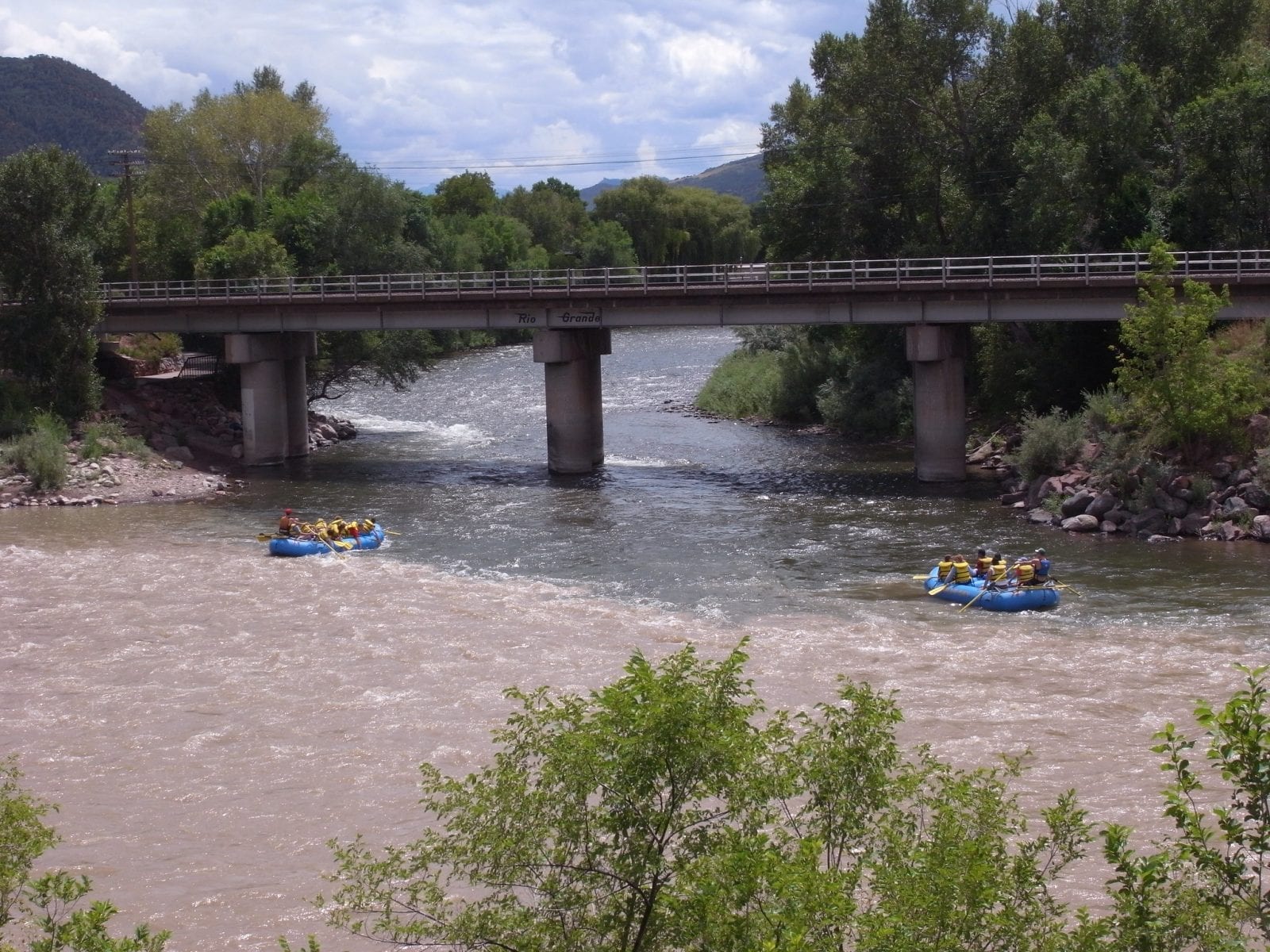 Image of two rafts floating down the Roaring Fork River in Colorado