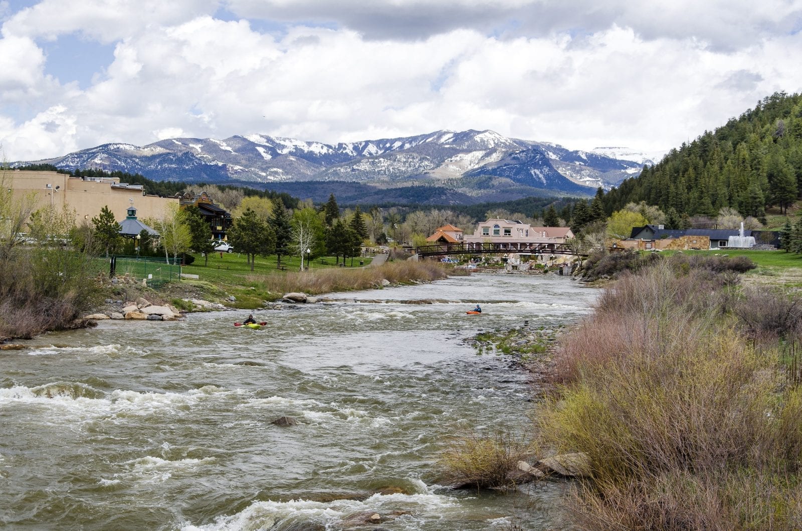 Image of the San Juan River flowing with mountains in the background in Colorado