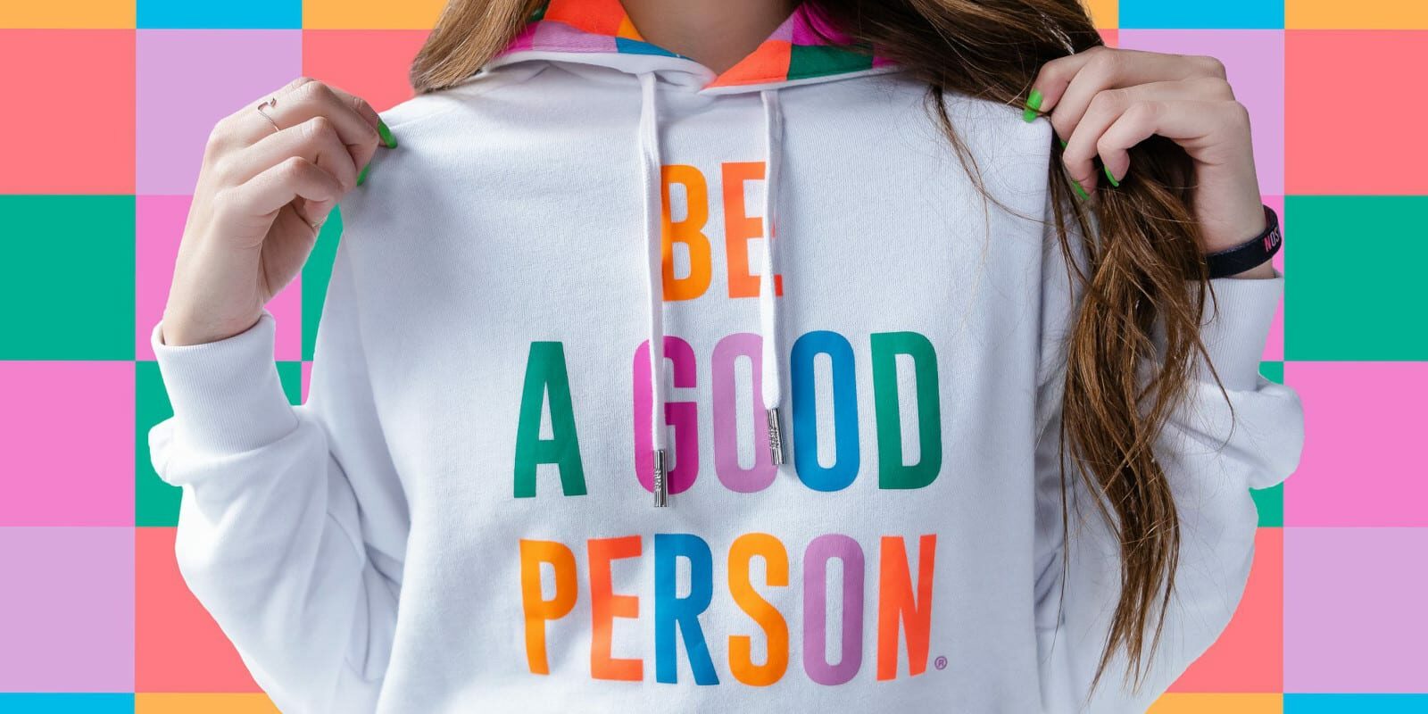 Image of a girl wearing a "Be A Good Person" hoodie