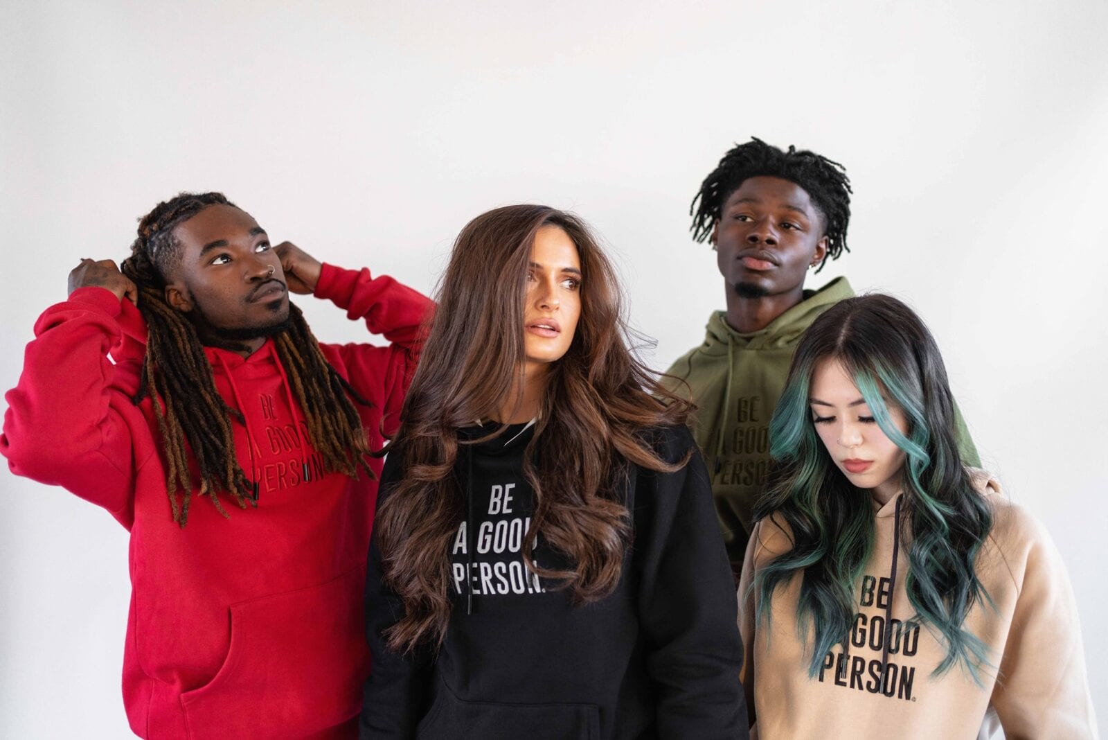 Image of four people wearing "Be A Good Person" hoodies