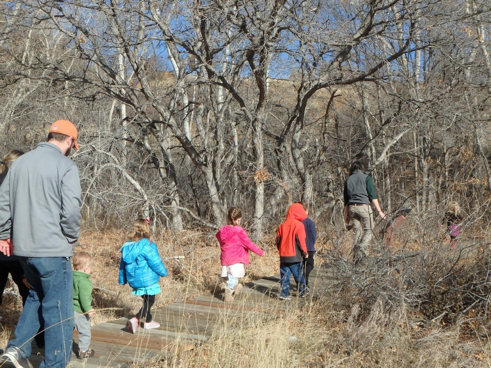 Image of parents and children hiking with a bear creek nature center guide in Colorado Springs, Colorado