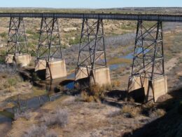 Image of the Canadian River in New Mexico with a railroad bridge crossing over