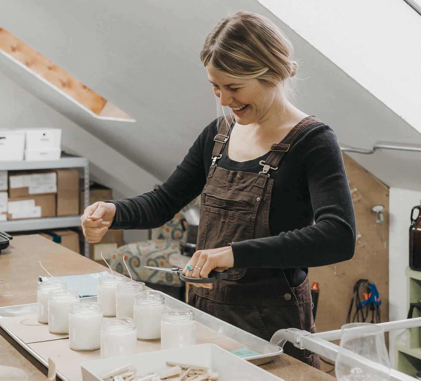 Image of a woman creating some of the Old Pine Candle Company candles