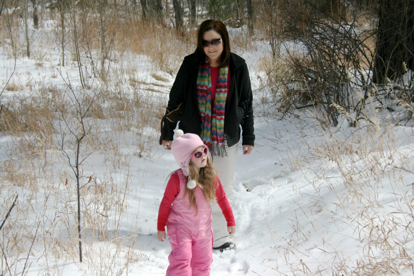 Image of a mom and daughter hiking in the snow at Reynolds Park in Conifer, Colorado