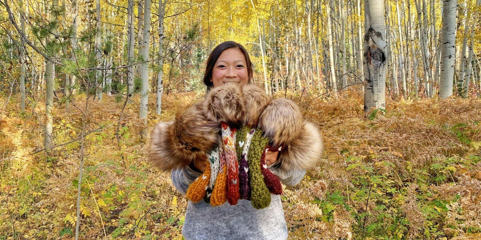 Image of Chereen, the owner, holding the beanies she knit