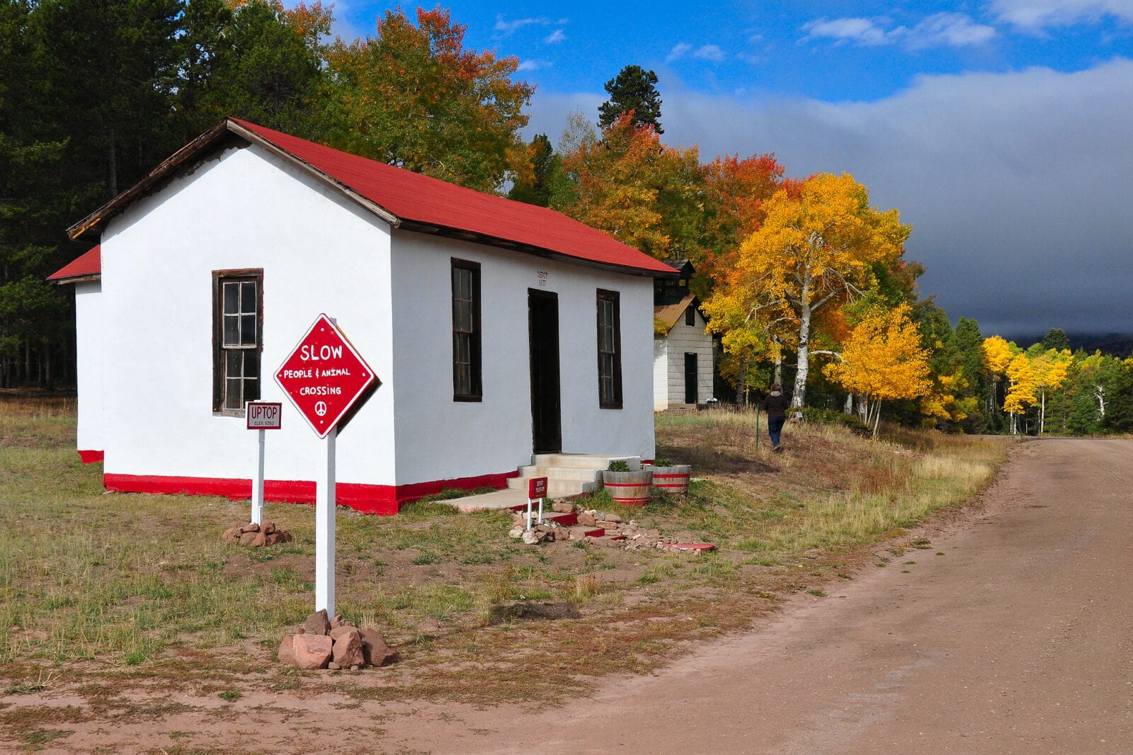 Image of a white building with red roof in autumn at Uptop ghost town in Colorado