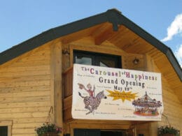 Image of the entrance sign for the Carousel of Happiness in Nederland, Colorado