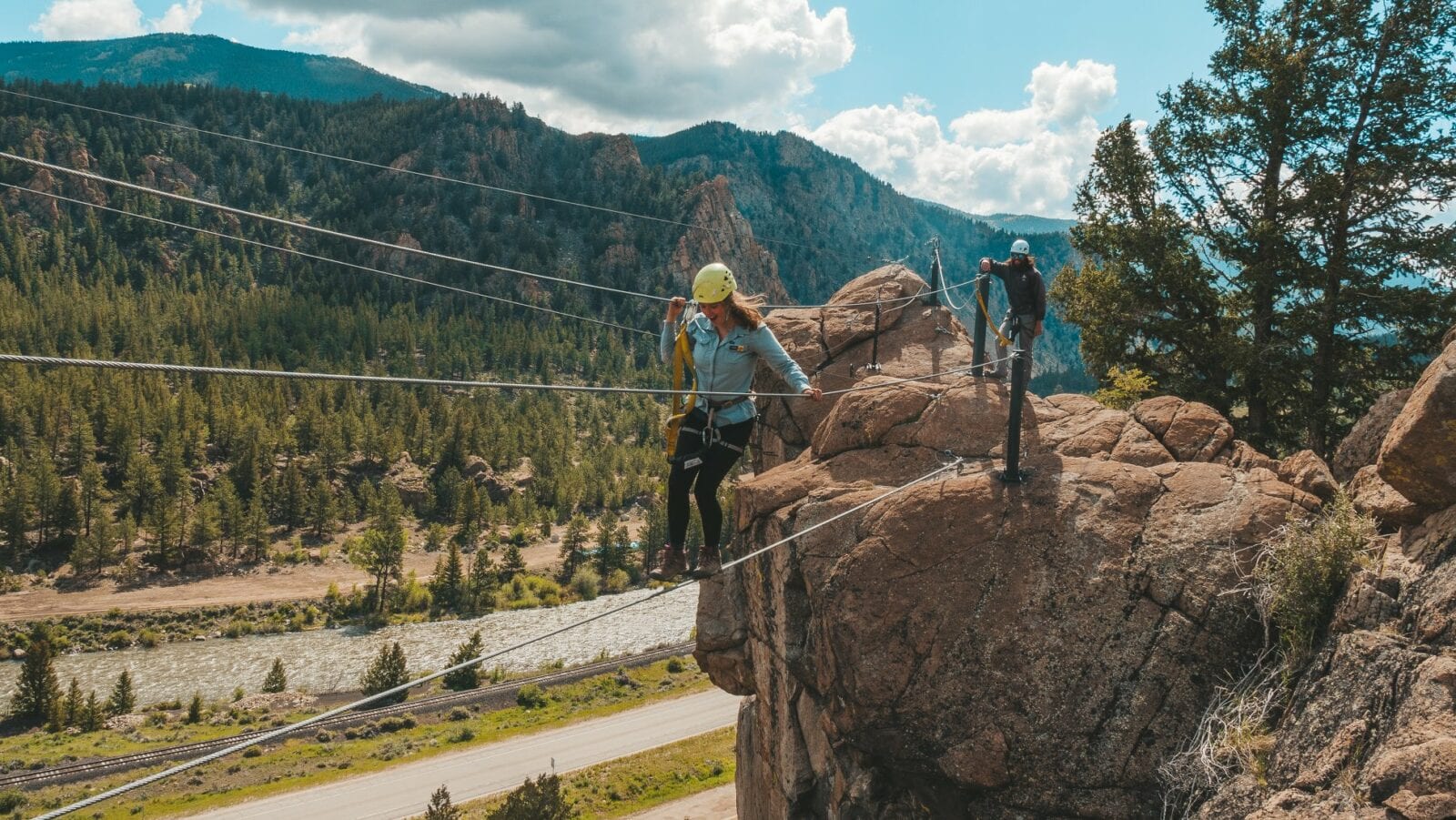 Image of a woman on a cable bridge on the Granite Via Ferrata course in Buena Vista, Colorado