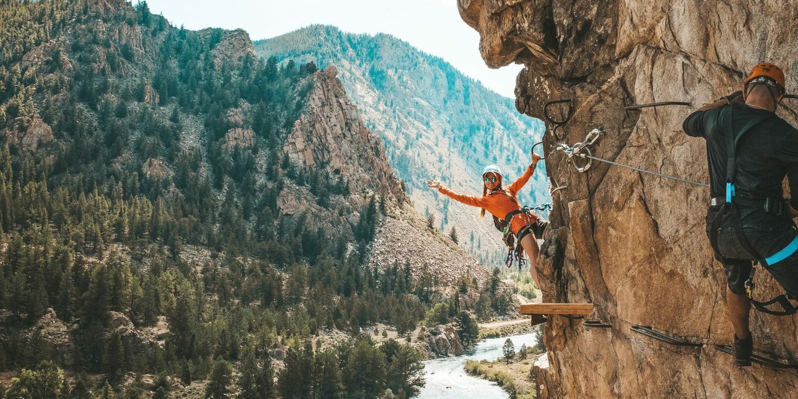 Image of a woman on the Granite Via Ferrata hanging off the cliff in Buena Vista, Colorado