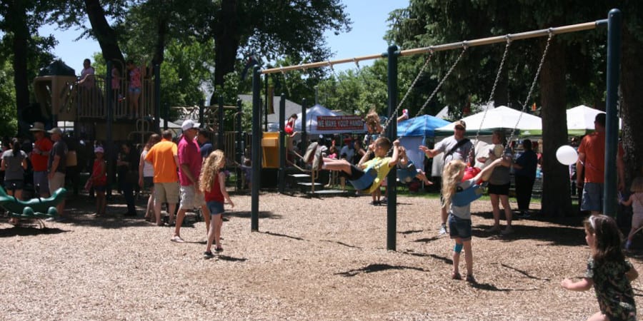 Image of kids playing on the playground at Parish Park in Johnstown, Colorado