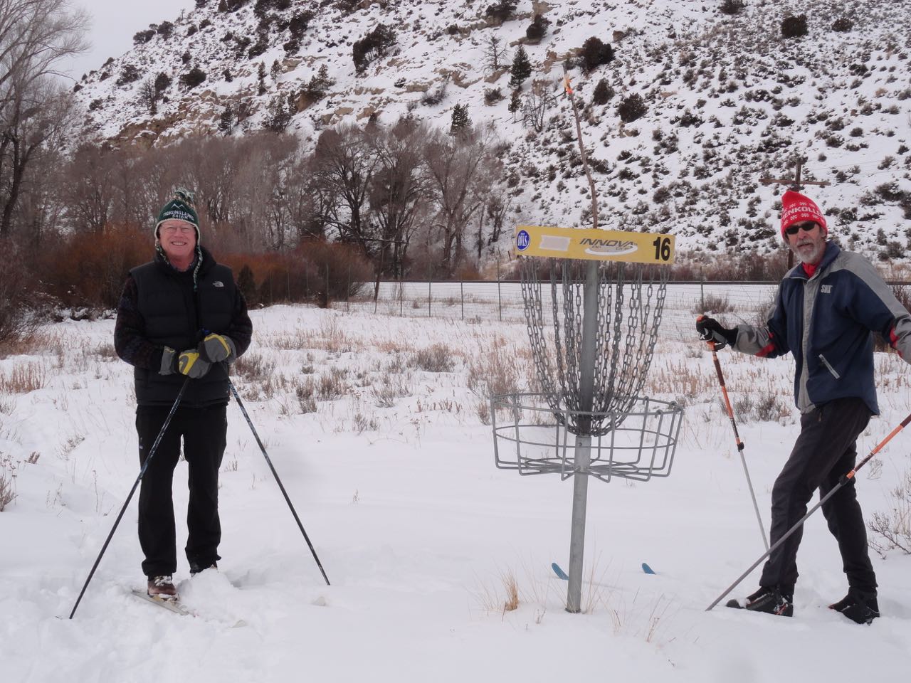 Image of two men playing disc golf in winter at 