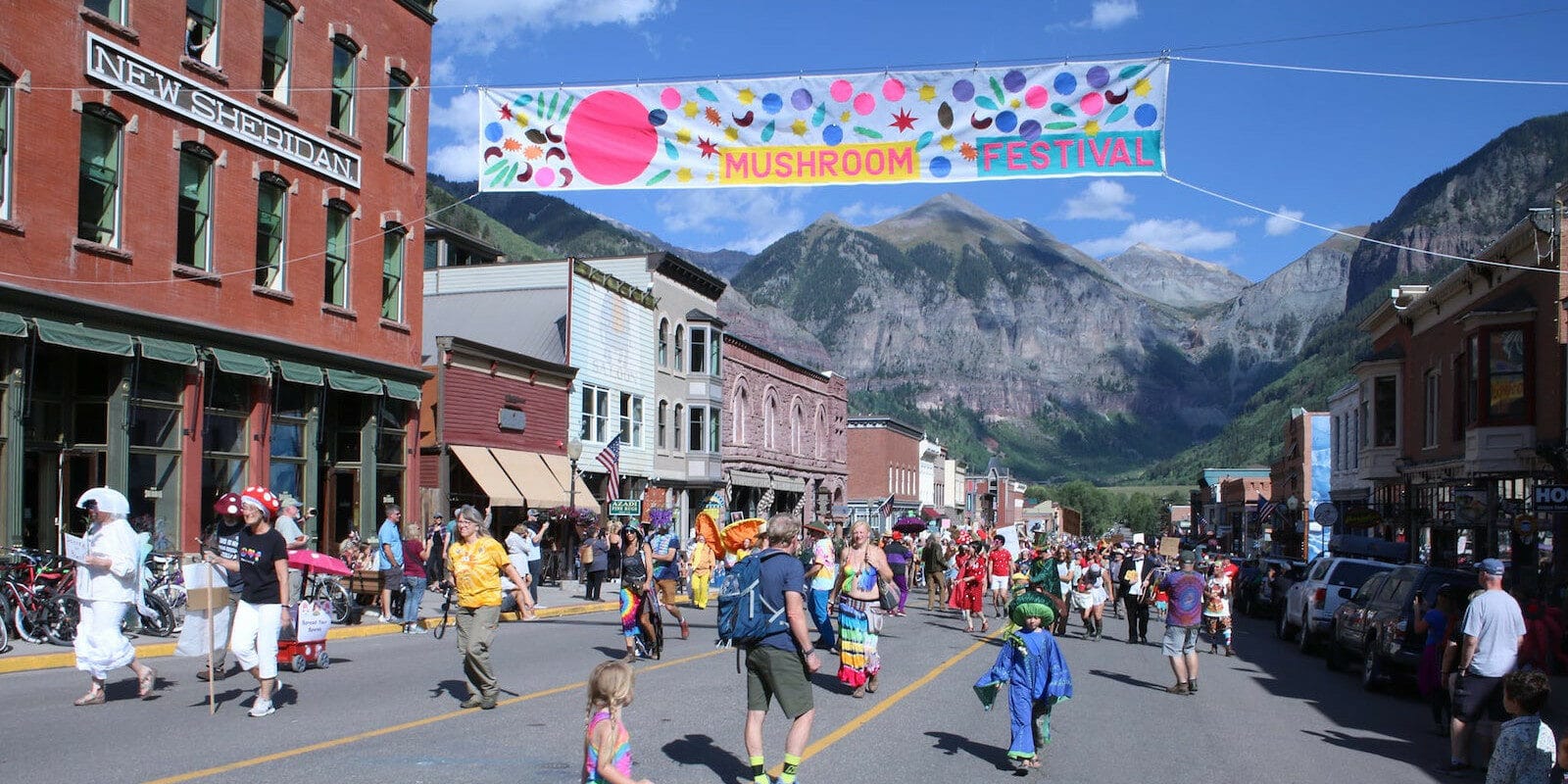 Image of the banner and festival-goers at the Telluride Mushroom Festival in Colorado