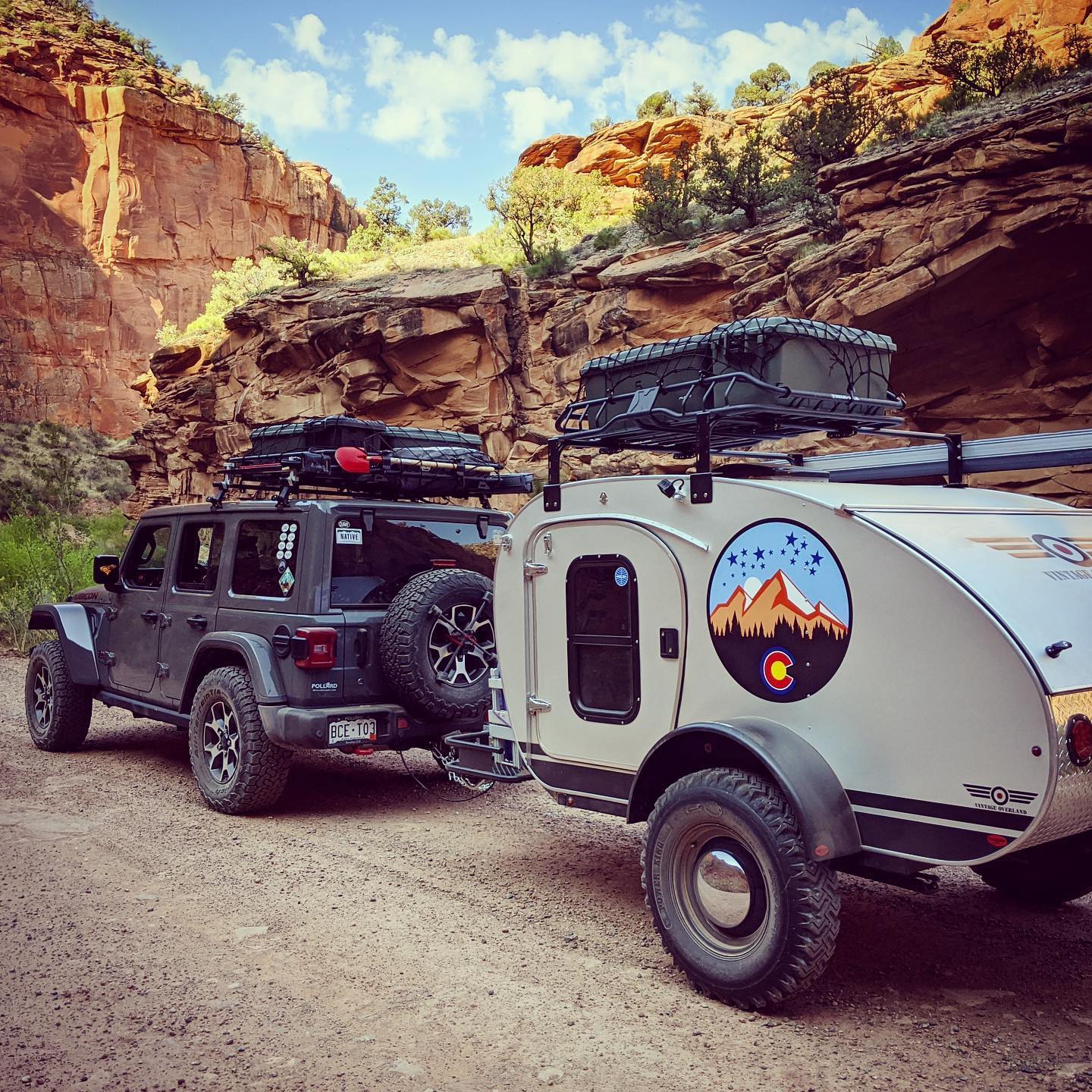 Image of a Vintage Overland trailer being towed by a jeep