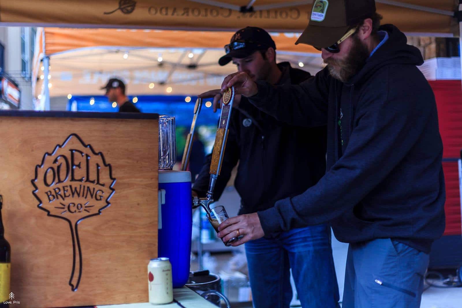 Image of guys at the Odell Brewing Co booth at Breckenridge Strings, Beers, and Ciders festival in colorado