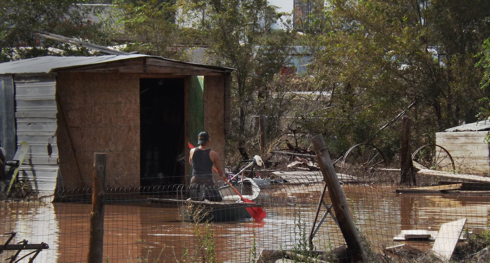 Image of a kayaker checking the damage of the 2013 Colorado flood