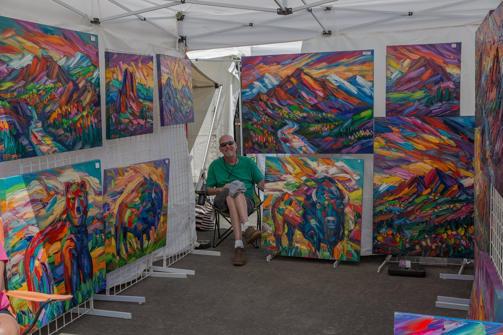 Image of a booth with paintings at the Crested Butte Arts Festival in Colorado