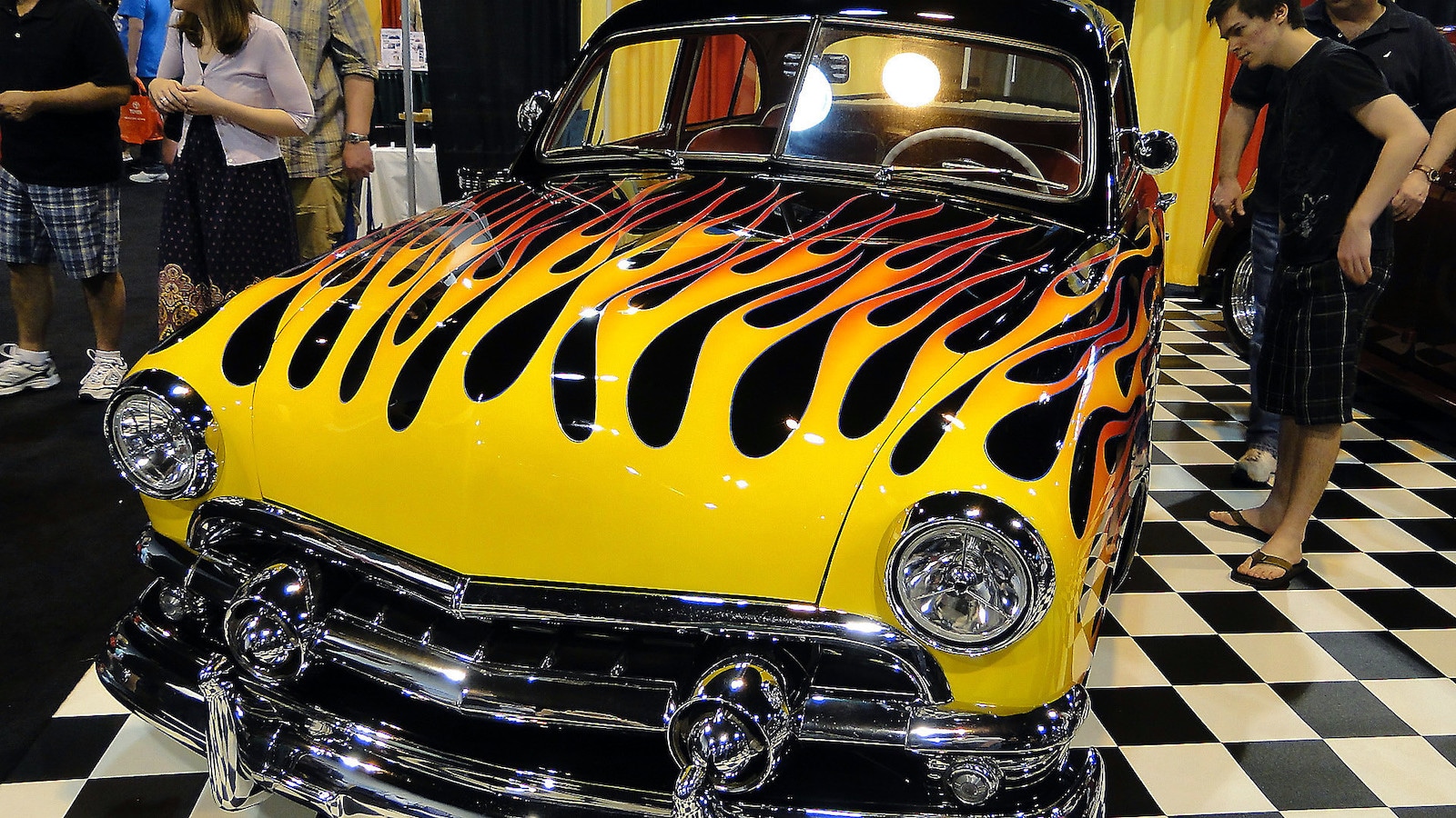 Image of a car at the Denver Auto Show with flames pained on the hood