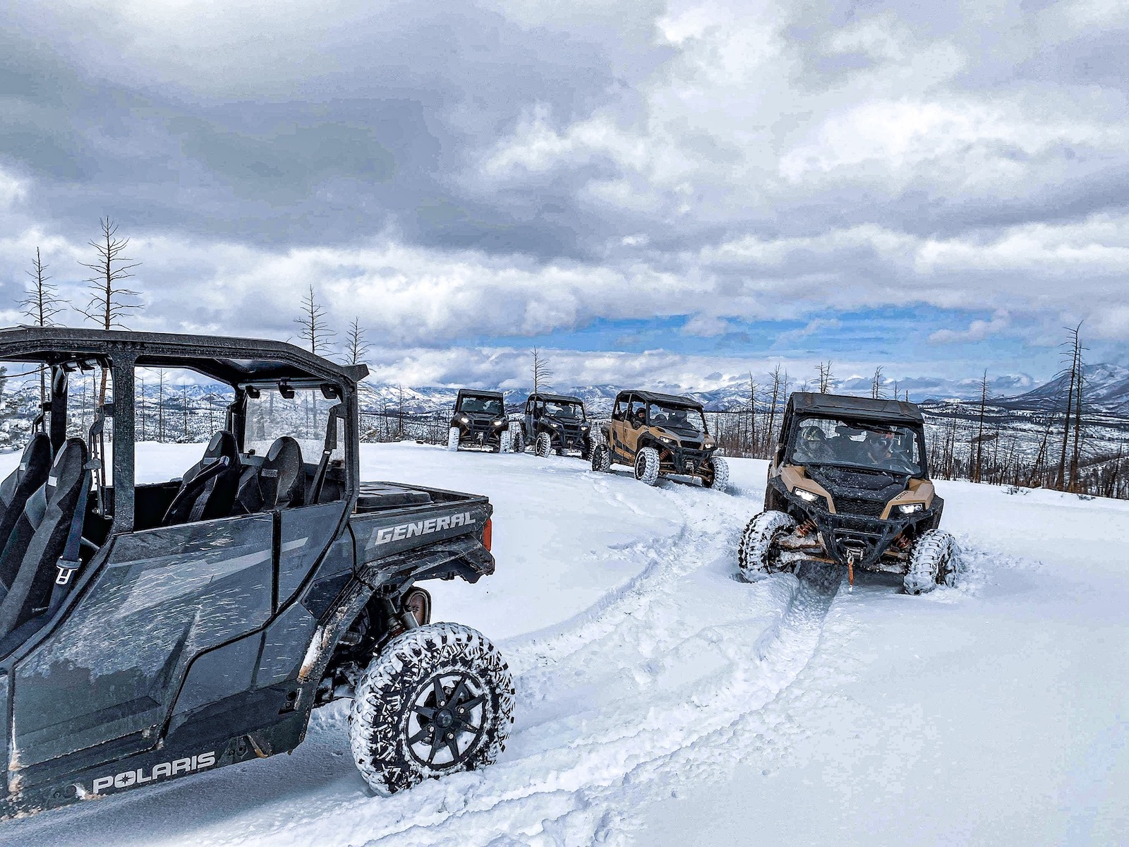 Image of snowy UTVs driving in colorado