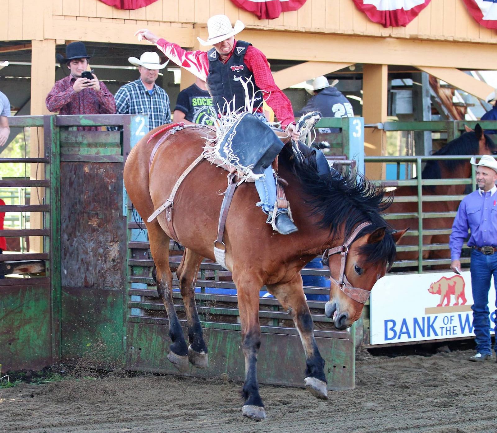 Image of a man riding a bucking horse at High Country Stampede Rodeo in Fraser, Colorado