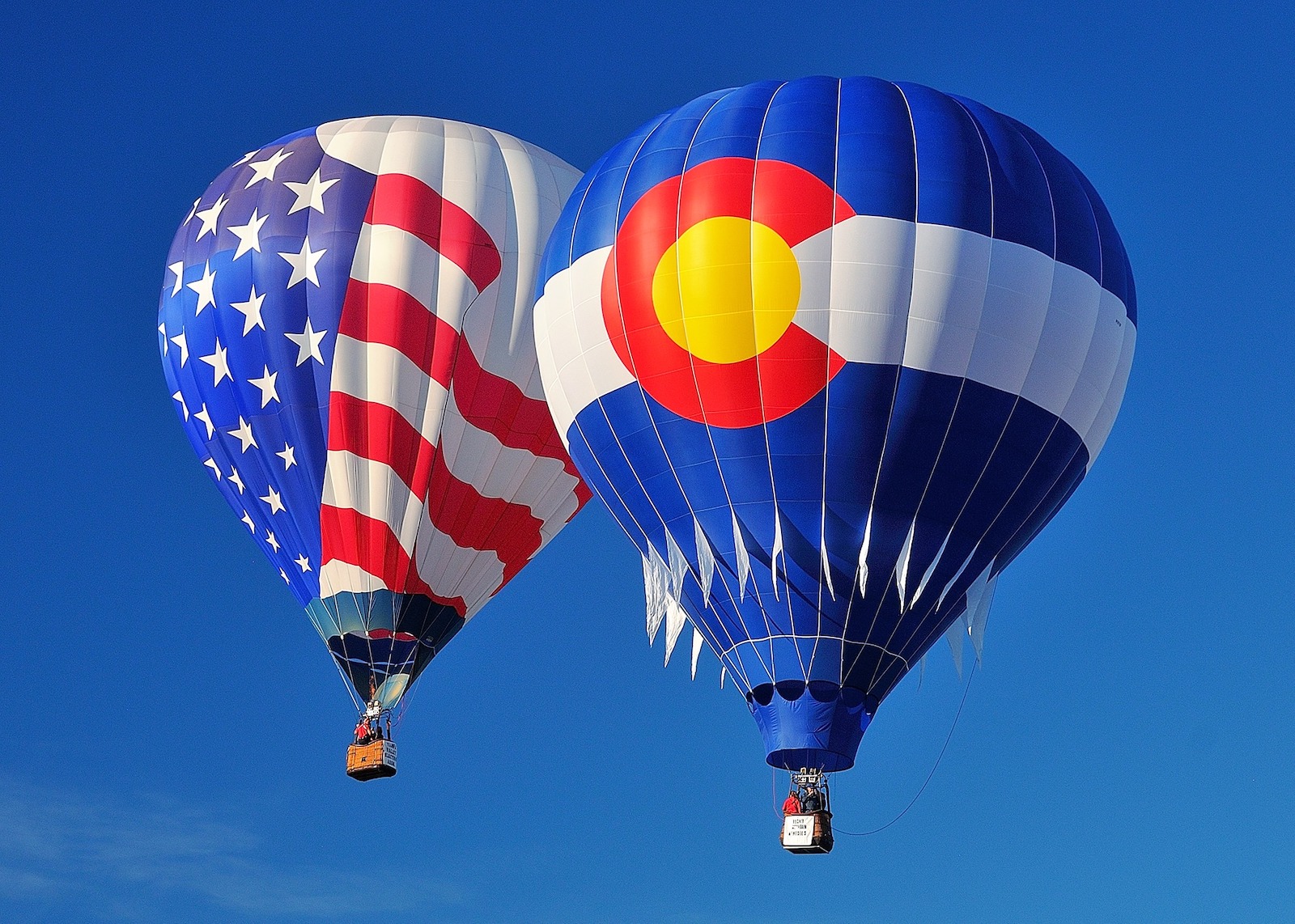 Image of a American flag and Colorado flag hot air balloon at the Steamboat Springs Hot Air Balloon Rodeo