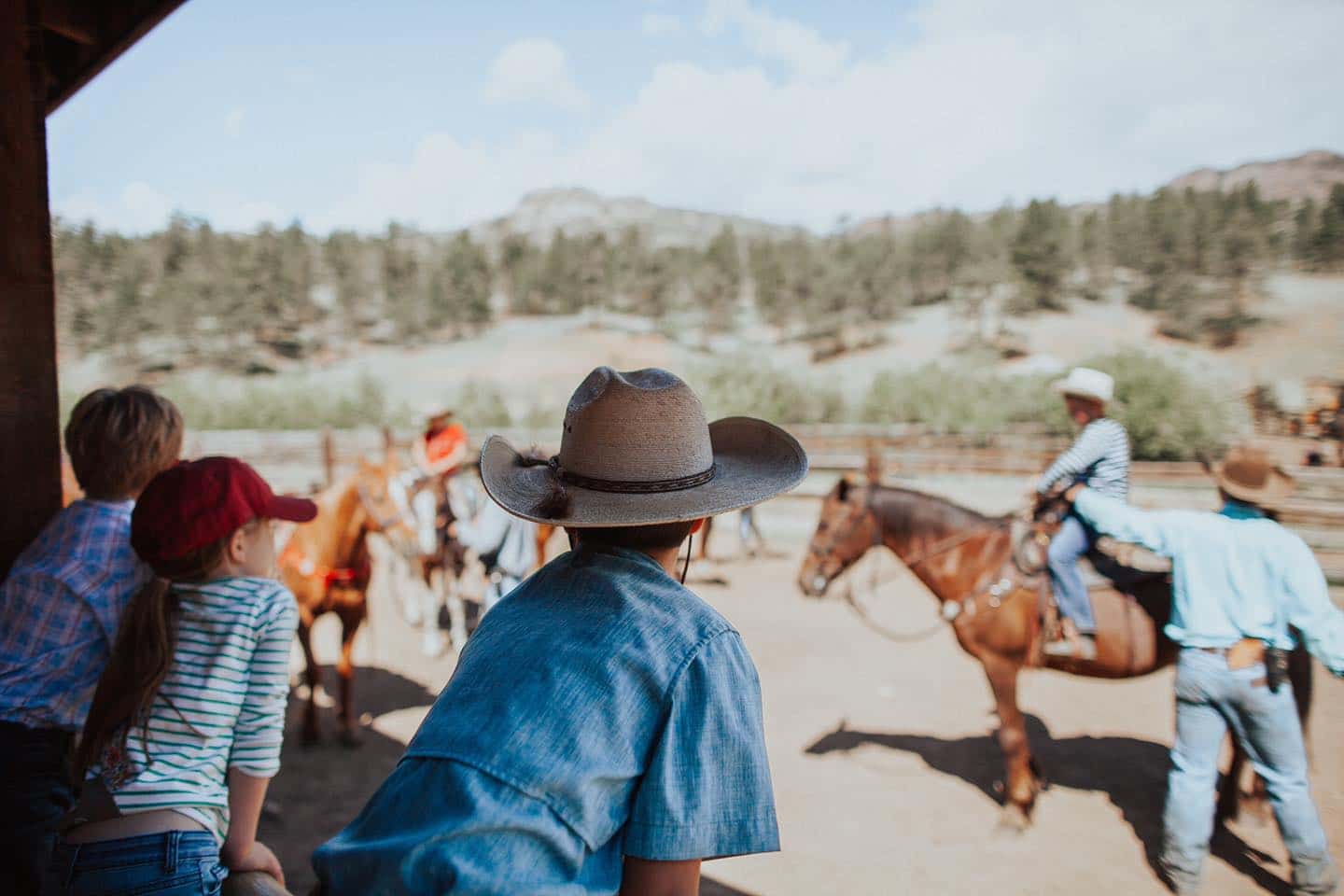 Image of kids watching people riding horses at Lost Valley Ranch in Sedalia, Colorado