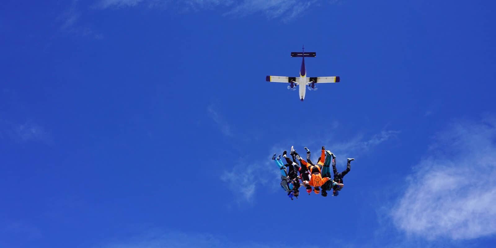 Image of skydivers falling to earth from a plane at Mile-Hi Skydiving Center in Longmont, CO