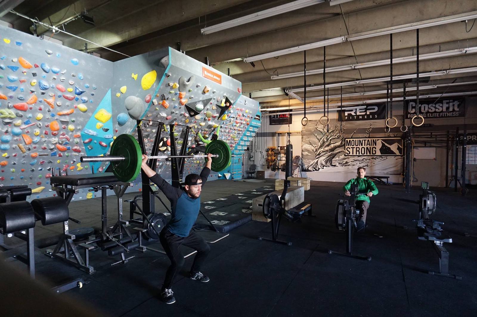 Image of a man lifting weights inside Mountain Strong in Denver, Colorado