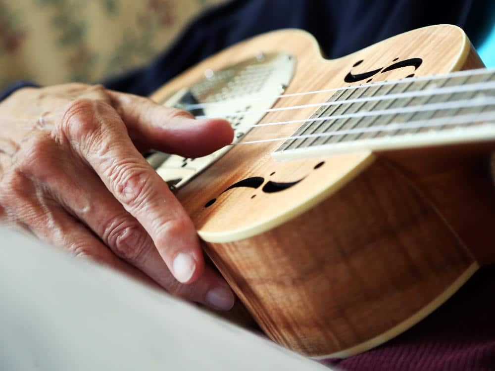 Image of a person playing a ukulele