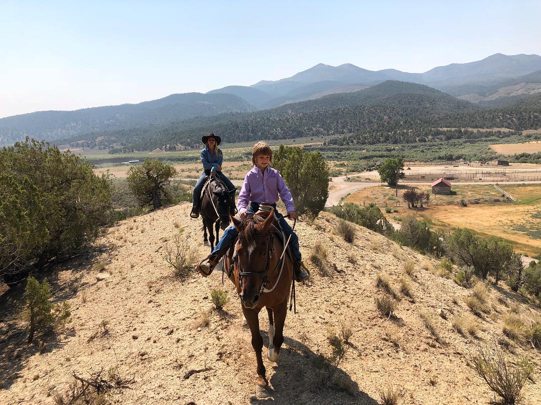 Image of people riding horses at The High Lonesome Ranch in De Beque, Colorado