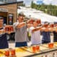 Image of people doing a stein hoist at the 10 Barrel Brewing Company booth at Brews and Tunes in Colorado