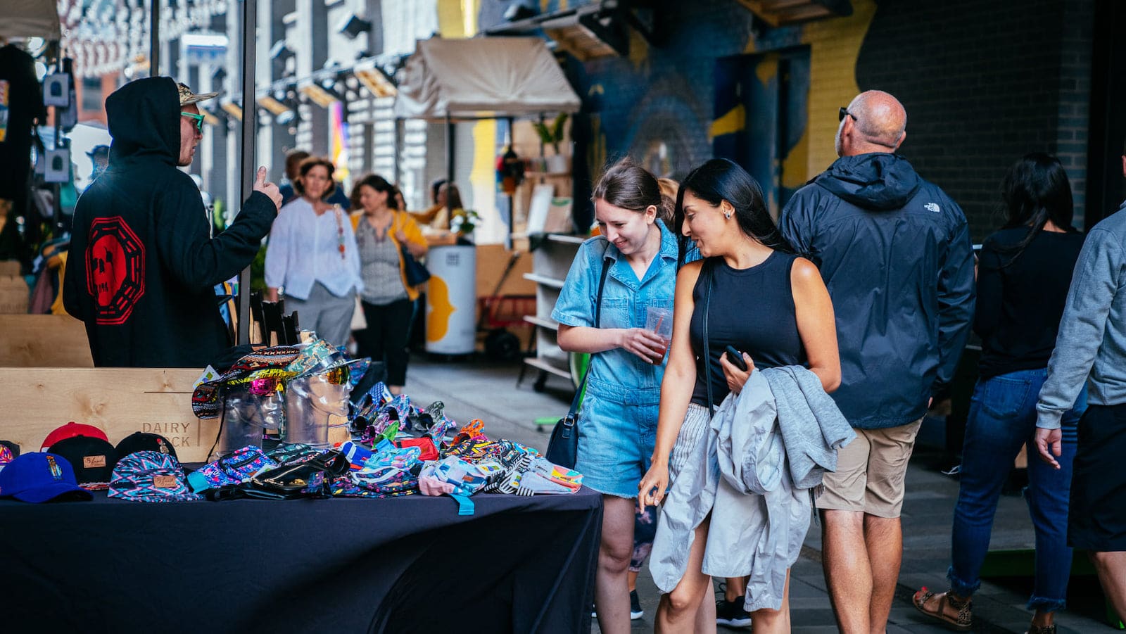 Image of people looking at a vendors items at Dairy Block in Denver, Colorado