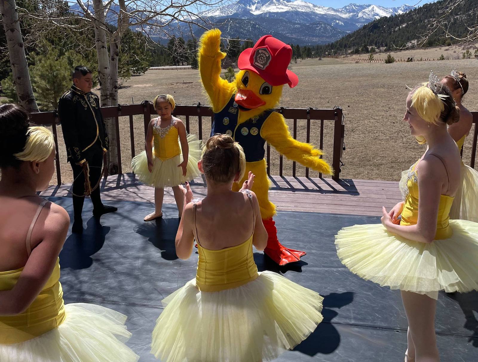 Image of a costume-wearing duck doing ballet with dancers at Estes Park Duck Race Festival in Colorado