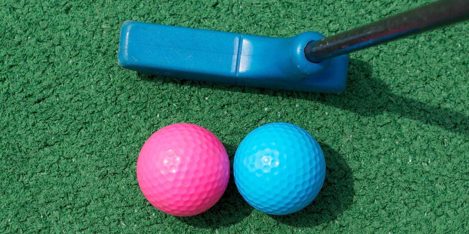 Image of a pink and blue golf ball and blue putter