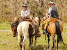 Image of two men riding horses at Rainbow Trout Ranch in Antonito, CO